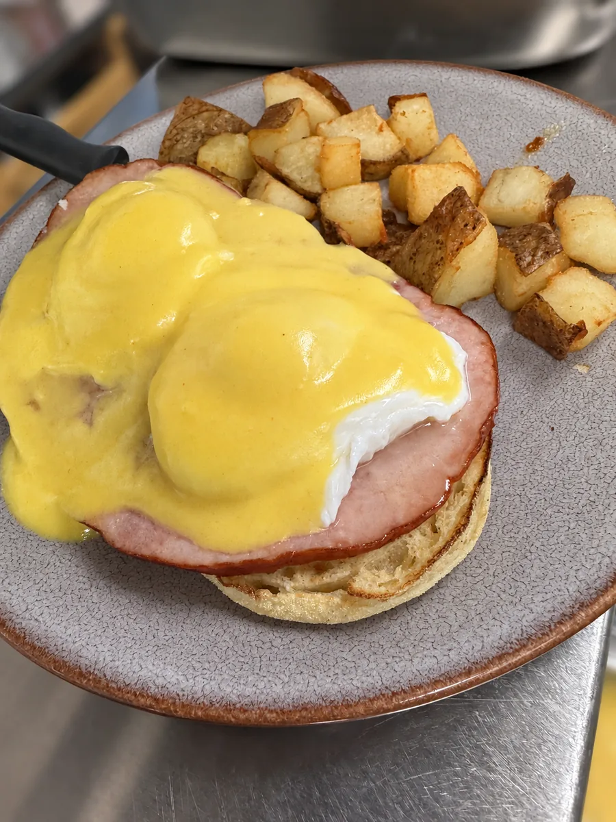 Ham eggs Benedict with hollandaise and home fries
